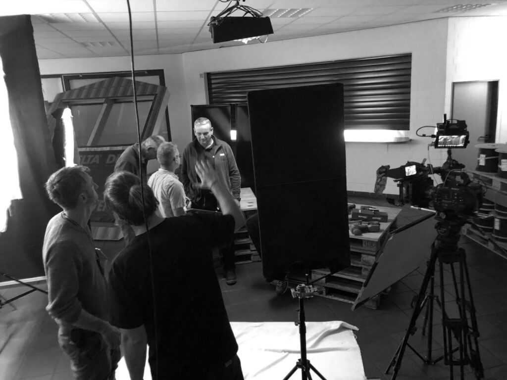 Making-of Bild beim Dreh der Videotutorials. Zu sehen ist das Studio, das Team bespricht die Beleuchtung und die Einrichtung der Kameras.